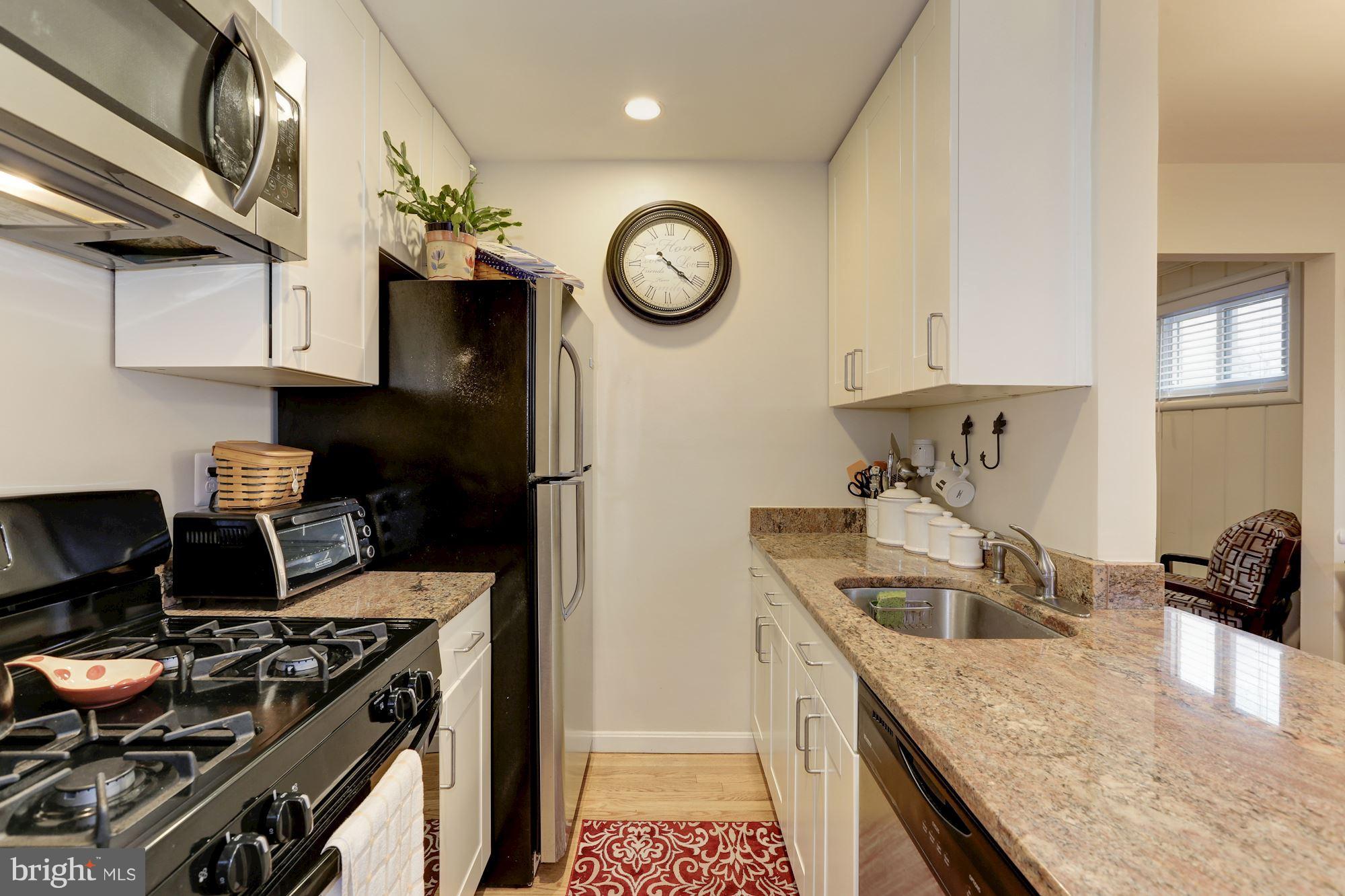 12503 Feldon Street Silver Spring, MD 20906 - Photo 8 of 18 a kitchen with a stove and a refrigerator