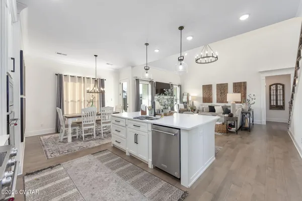 a large kitchen with a table and chairs