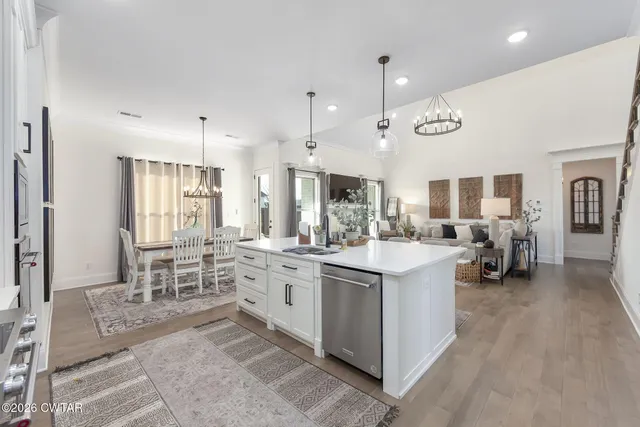 a large kitchen with a table and chairs