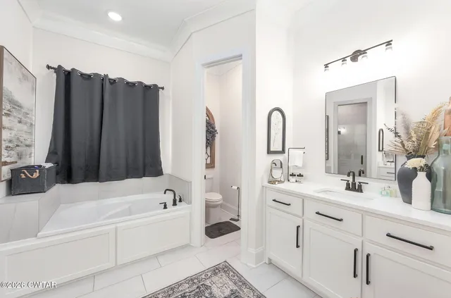 a bathroom with a double vanity sink mirror double and bathtub