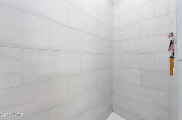 a bedroom with a bed and a large window with the outer view