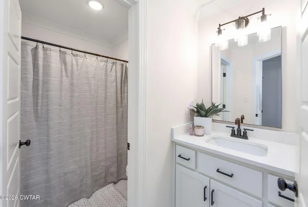a bedroom with a large bed couch and a window
