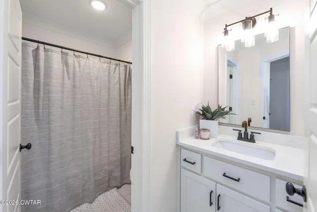 a bedroom with a large bed couch and a window