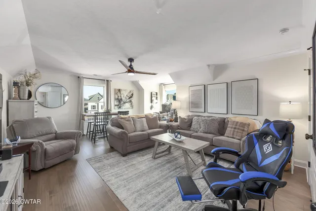 a view of a livingroom with furniture and a window