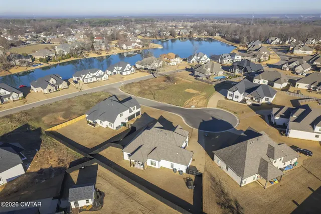 an aerial view of a house with a swimming pool