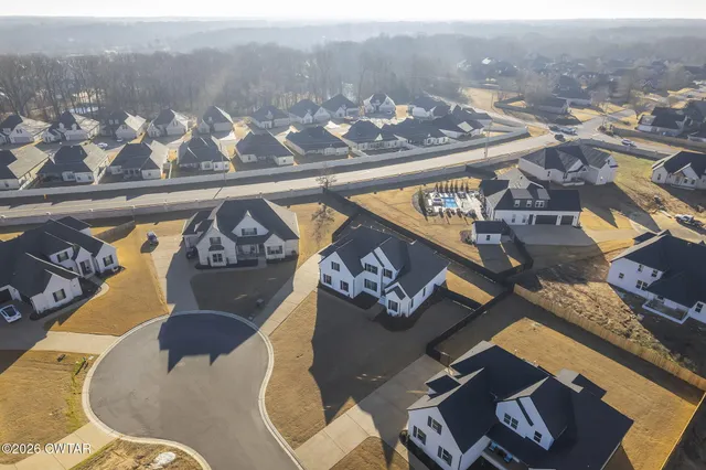 an aerial view of a house with a lake view