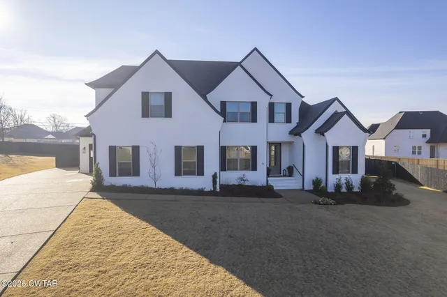 an aerial view of house with yard and ocean view