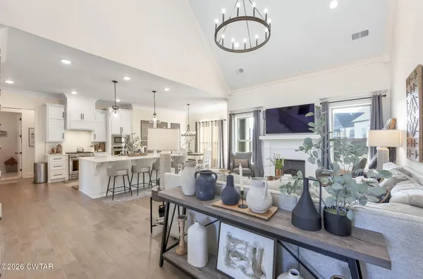 a living room with furniture a rug and a large window