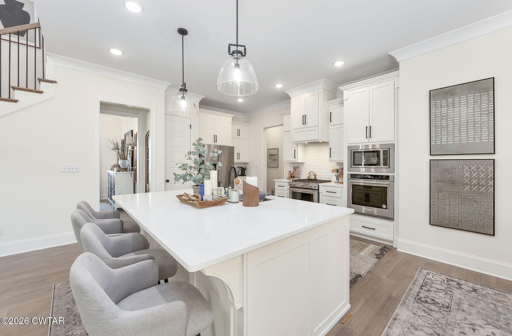 23 Clearwater Cove Jackson, TN 38305 - Photo 8 of 60 a kitchen with stainless steel appliances kitchen island granite countertop a refrigerator a stove a sink a dining table and chairs with wooden floor