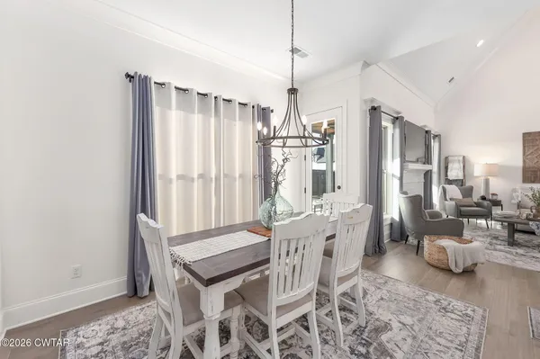 a large white kitchen with a large island oven a sink stainless steel appliances and cabinets
