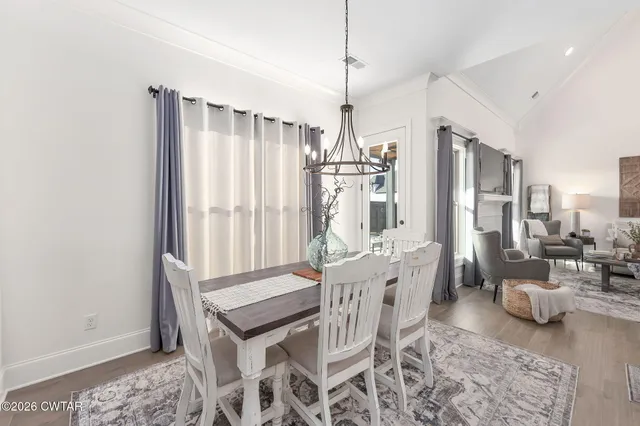a large white kitchen with a large island oven a sink stainless steel appliances and cabinets