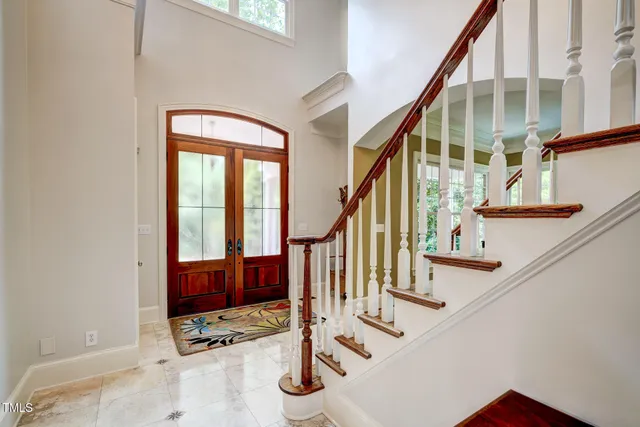 a kitchen with granite countertop white cabinets and a window
