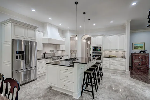 a room with pool tables and wooden floor