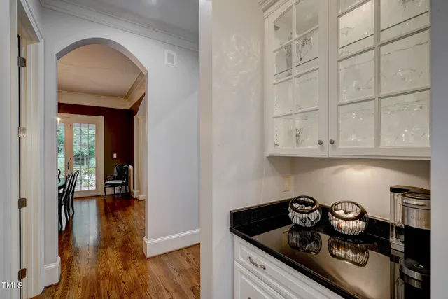 a view of backyard with wooden fence and large trees