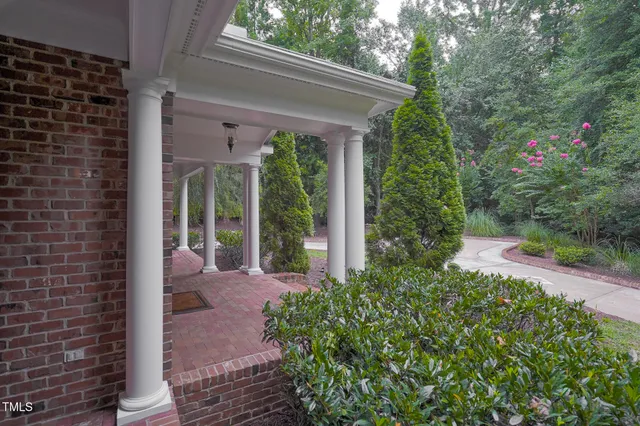 a living room with furniture a wooden floor and a large window