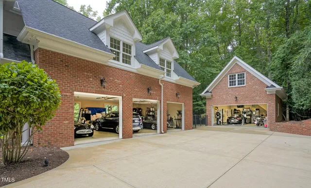 a dining room with wooden floor a chandelier a wooden table and chairs