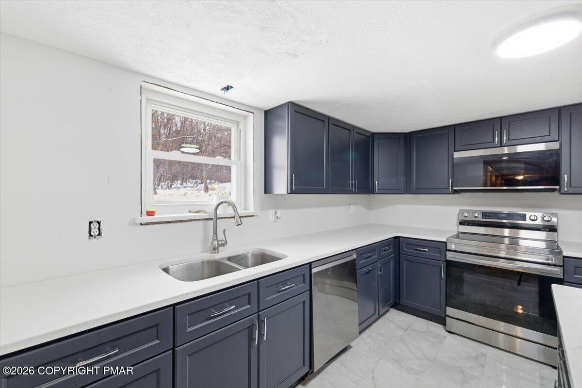 3529 Winding Way Kunkletown, PA 18058 - Photo 11 of 37 a kitchen with sink a microwave a stove and cabinets