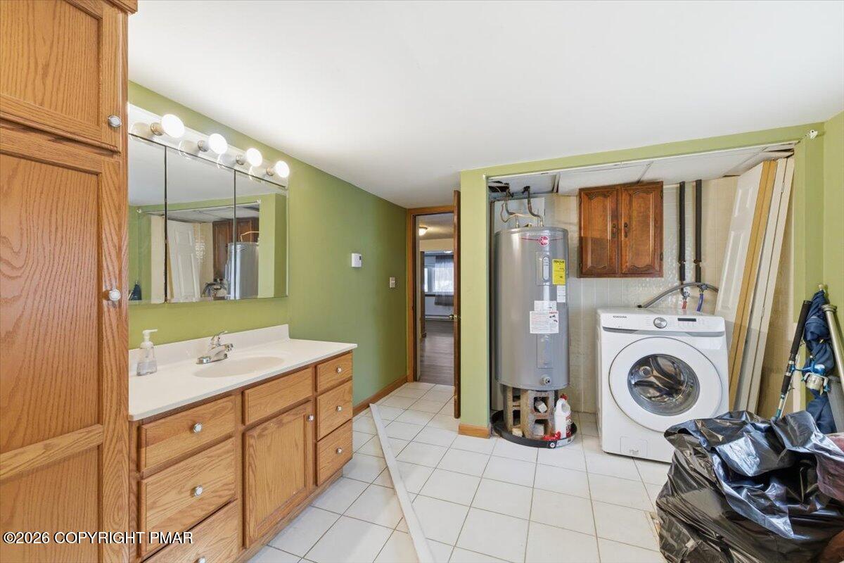 3529 Winding Way Kunkletown, PA 18058 - Photo 18 of 37 a bathroom with a sink a washing machine and a mirror