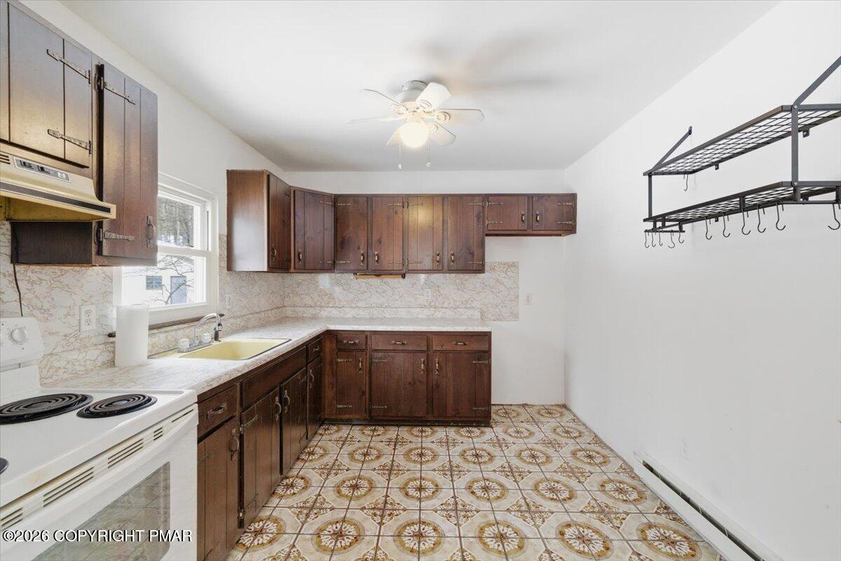 3529 Winding Way Kunkletown, PA 18058 - Photo 25 of 37 a kitchen with stainless steel appliances a sink stove and cabinets