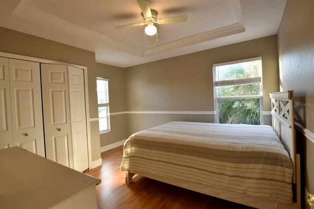 a bedroom with a large bed and a large window