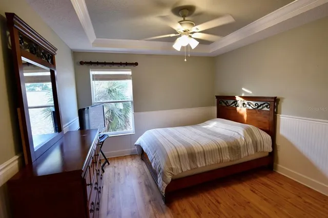 a view of an empty room with a chandelier fan