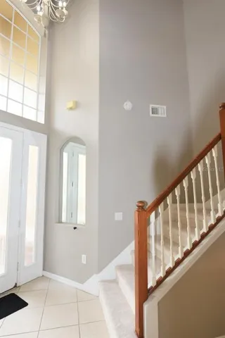 a view of staircase with living room and white walls