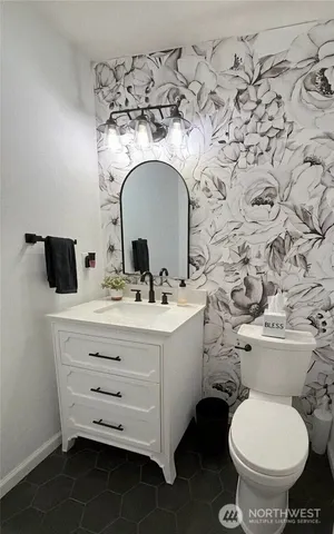 a bathroom with a toilet sink and mirror