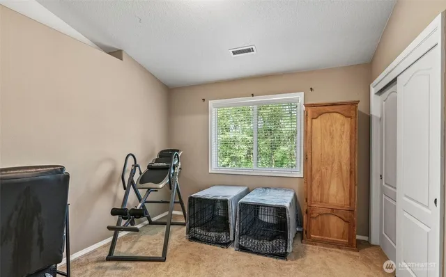 a view of a workspace with furniture and a window