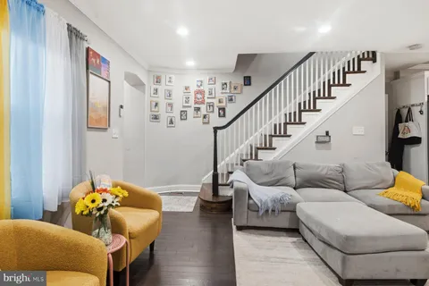 a living room with furniture and wooden floor