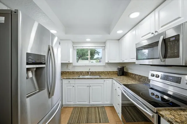 a kitchen with a sink stove and refrigerator