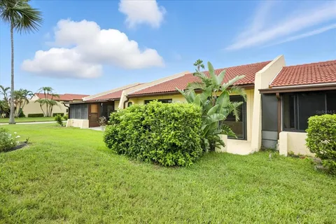 a front view of a house with a yard and porch