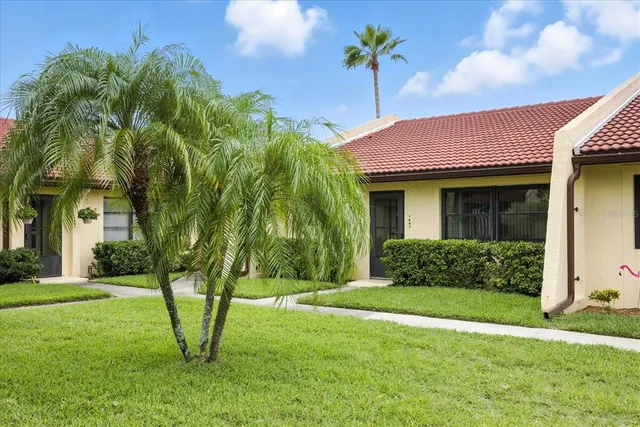 a view of a house with a yard and table