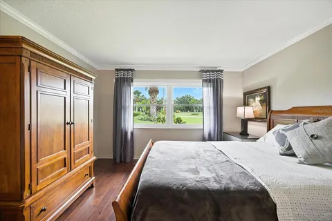 a bedroom with a bed and a large window with outer view