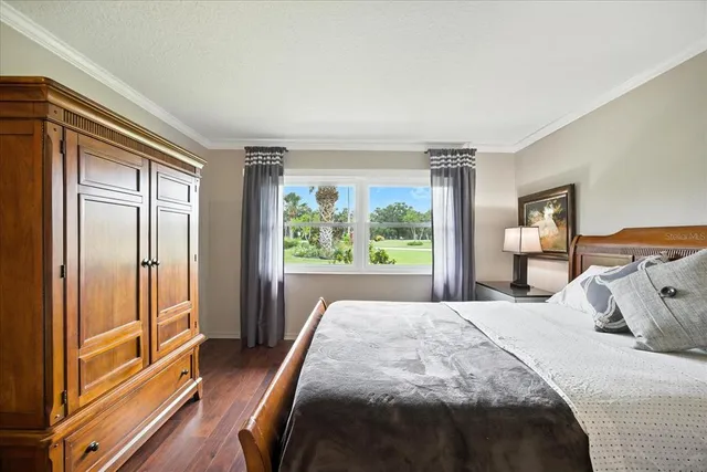 a bedroom with a bed and a large window with outer view