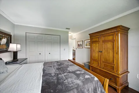 a view of a bedroom with wooden floor and bathroom