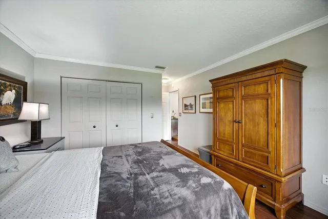 a view of a bedroom with wooden floor and bathroom