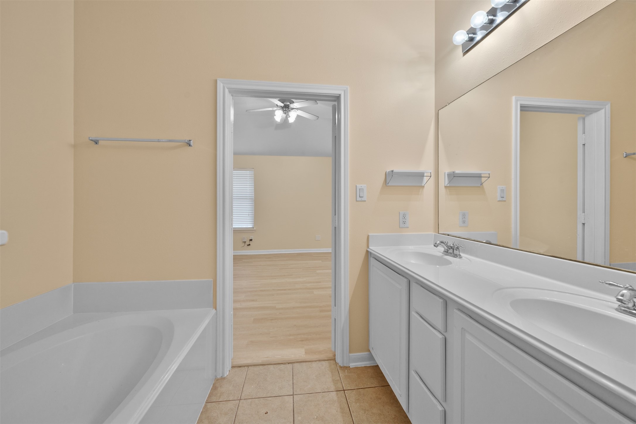 12119 Lakewood Villa Drive Tomball, TX 77377 - Photo 11 of 19 a bathroom with a tub sink and mirror