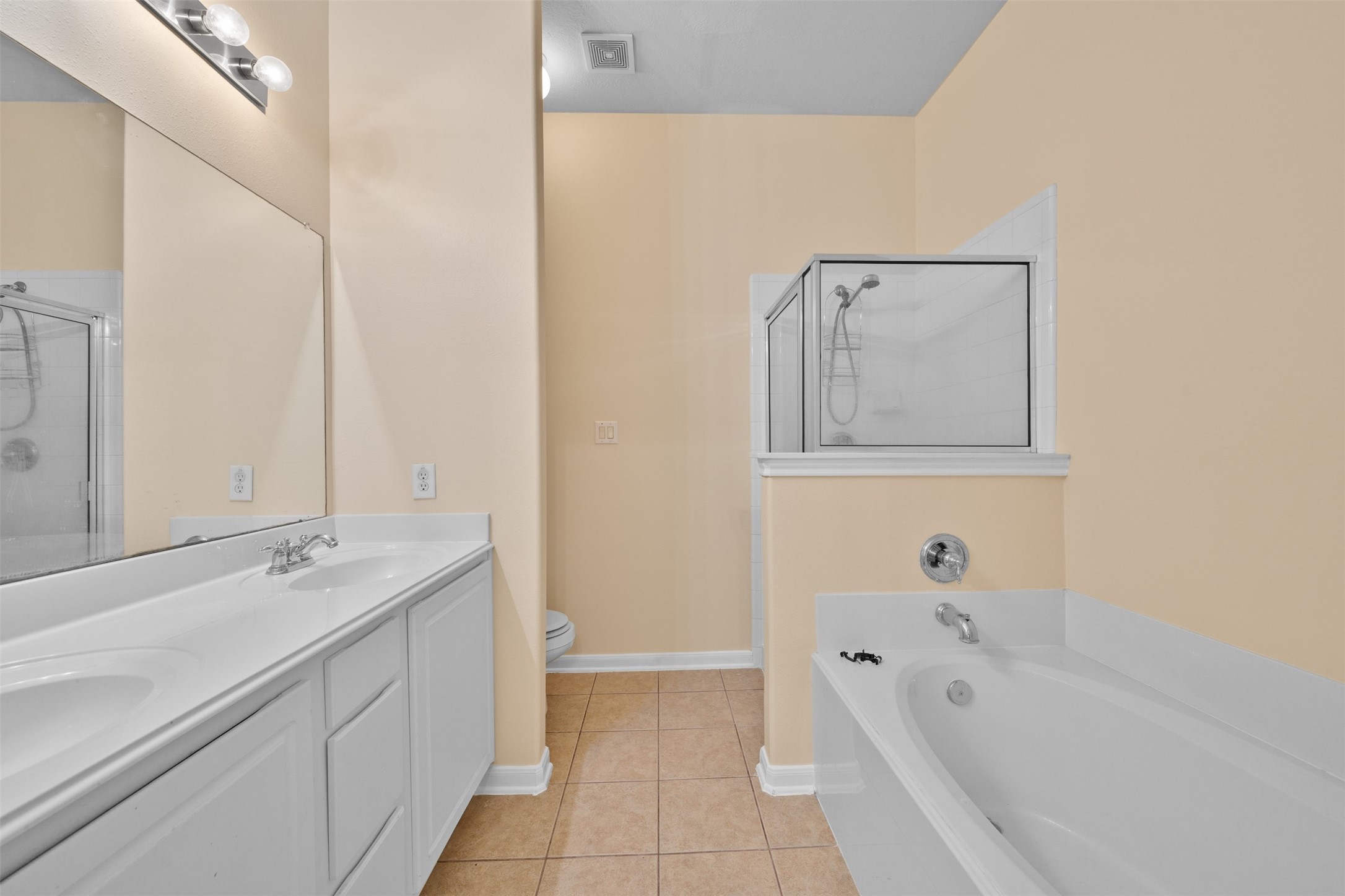12119 Lakewood Villa Drive Tomball, TX 77377 - Photo 12 of 19 a spacious bathroom with a tub sink and mirror
