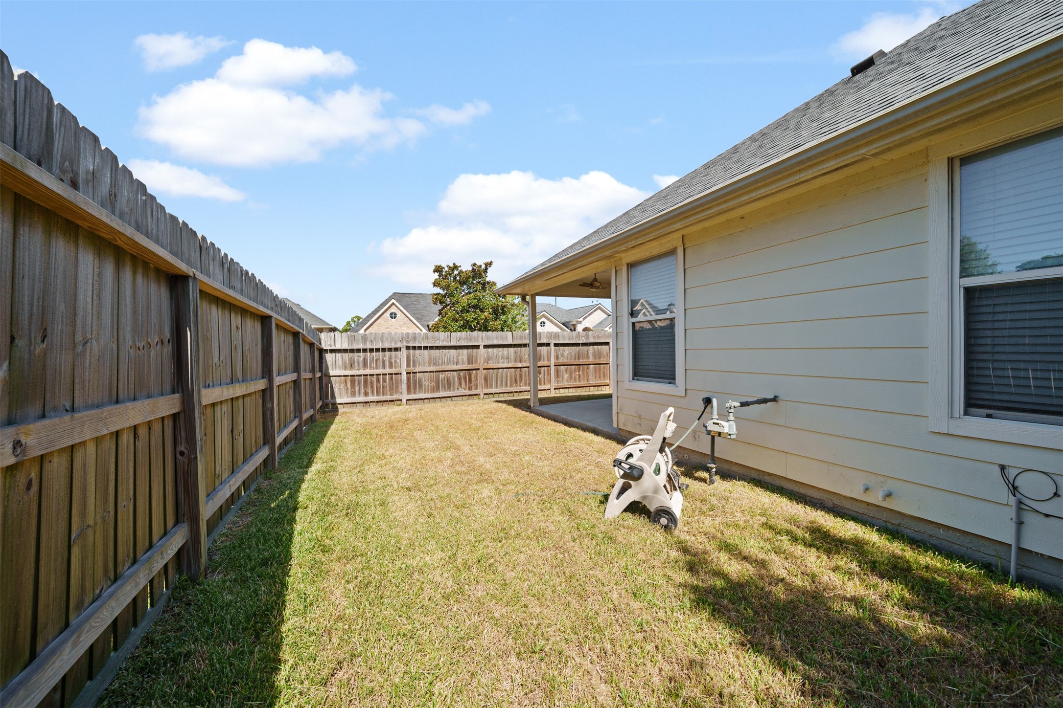 12119 Lakewood Villa Drive Tomball, TX 77377 - Photo 18 of 19 a view of backyard with swimming pool and wooden fence