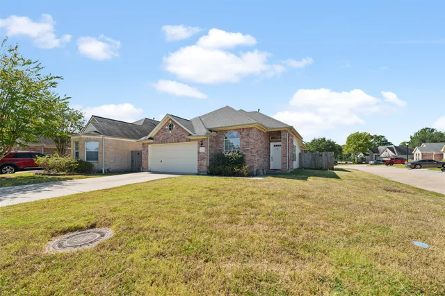 a large house with a big yard and large trees