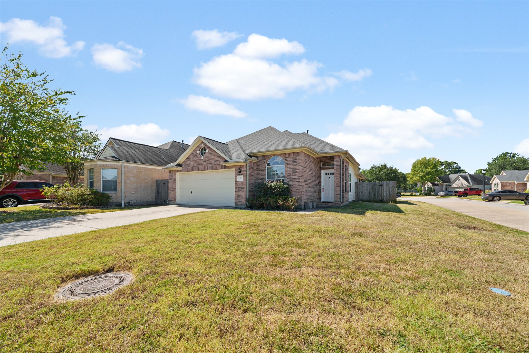 12119 Lakewood Villa Drive Tomball, TX 77377 - Photo 2 of 19 a large house with a big yard and large trees