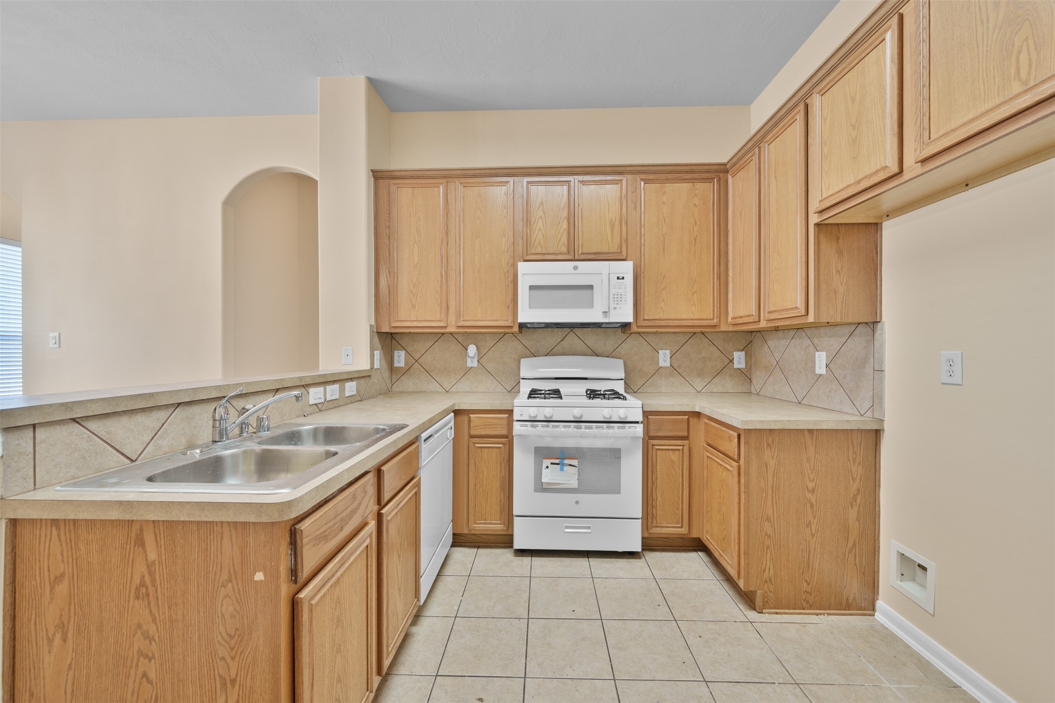 12119 Lakewood Villa Drive Tomball, TX 77377 - Photo 3 of 19 a kitchen with a sink stove and cabinets