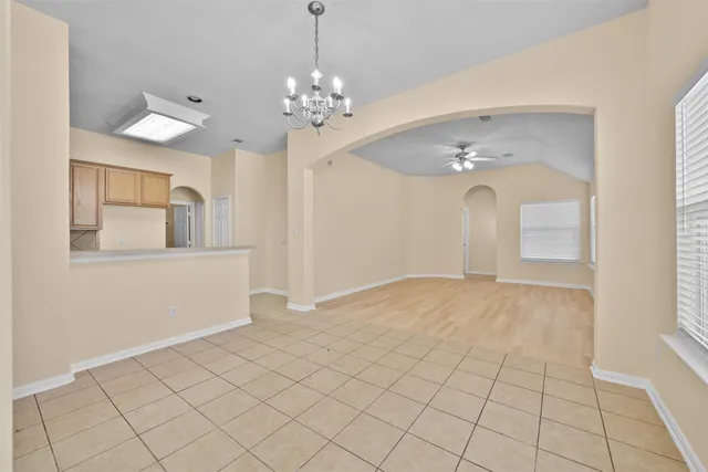a view of an empty room with chandelier