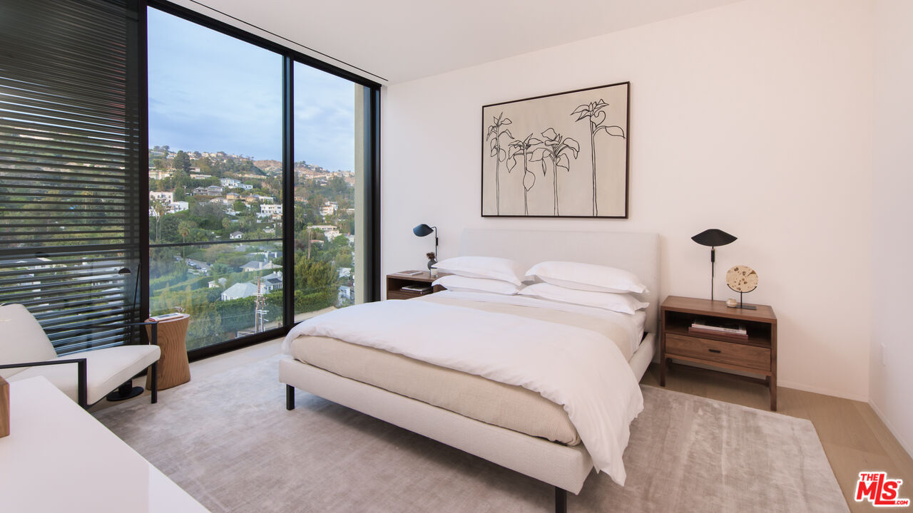 9040 Sunset Boulevard, Unit PHA West Hollywood, CA 90069 - Photo 22 of 30 a bedroom with a large bed and a large window