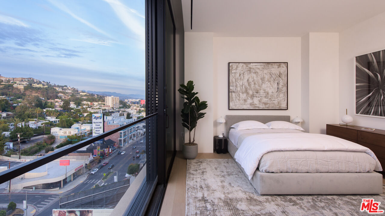 9040 Sunset Boulevard, Unit PHA West Hollywood, CA 90069 - Photo 24 of 30 a bed sitting in a bedroom next to a window