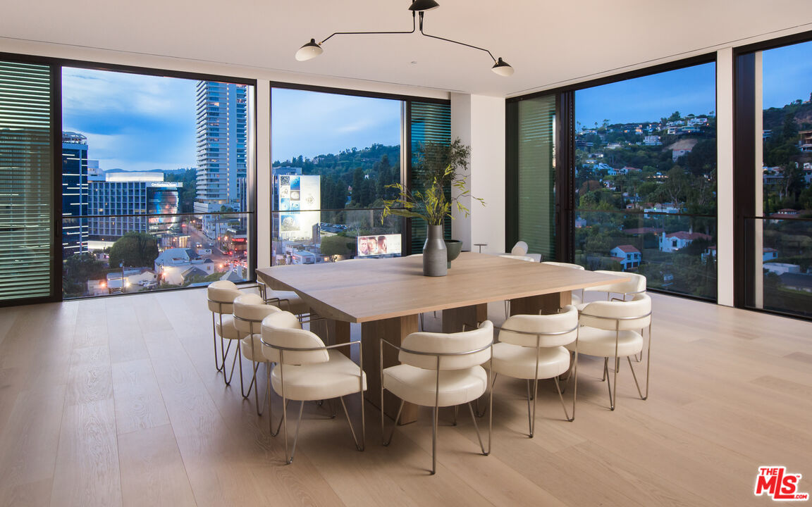 9040 Sunset Boulevard, Unit PHA West Hollywood, CA 90069 - Photo 4 of 30 a dining room with furniture and a floor to ceiling window