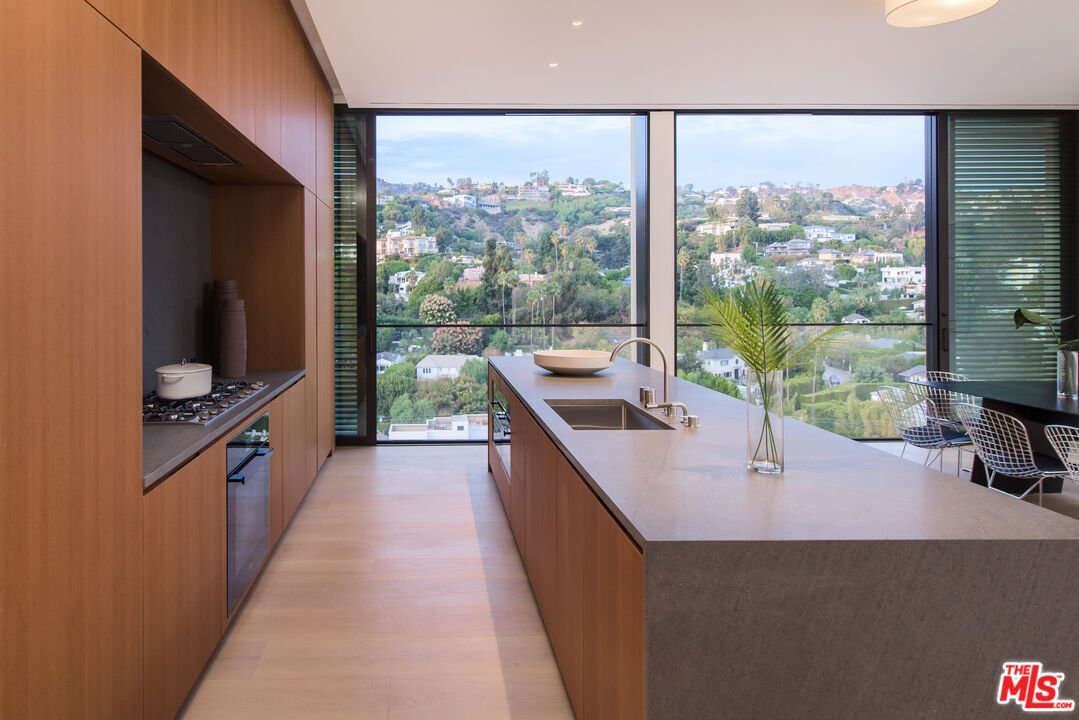 9040 Sunset Boulevard, Unit PHA West Hollywood, CA 90069 - Photo 8 of 30 a kitchen with a large window and a view of living room