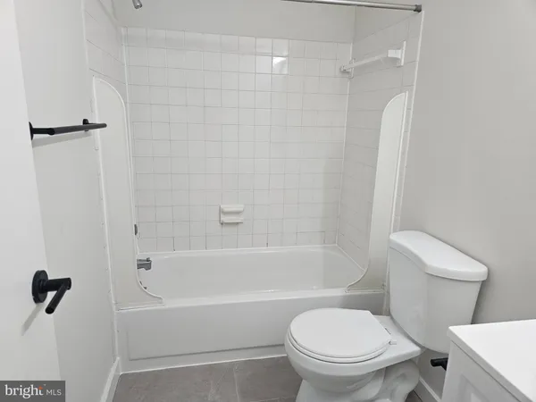 a bathroom with a toilet and a bathtub