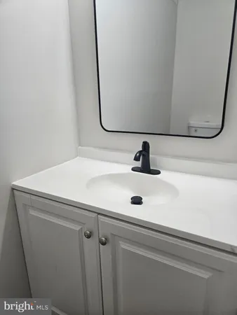 a bathroom with a sink and mirror