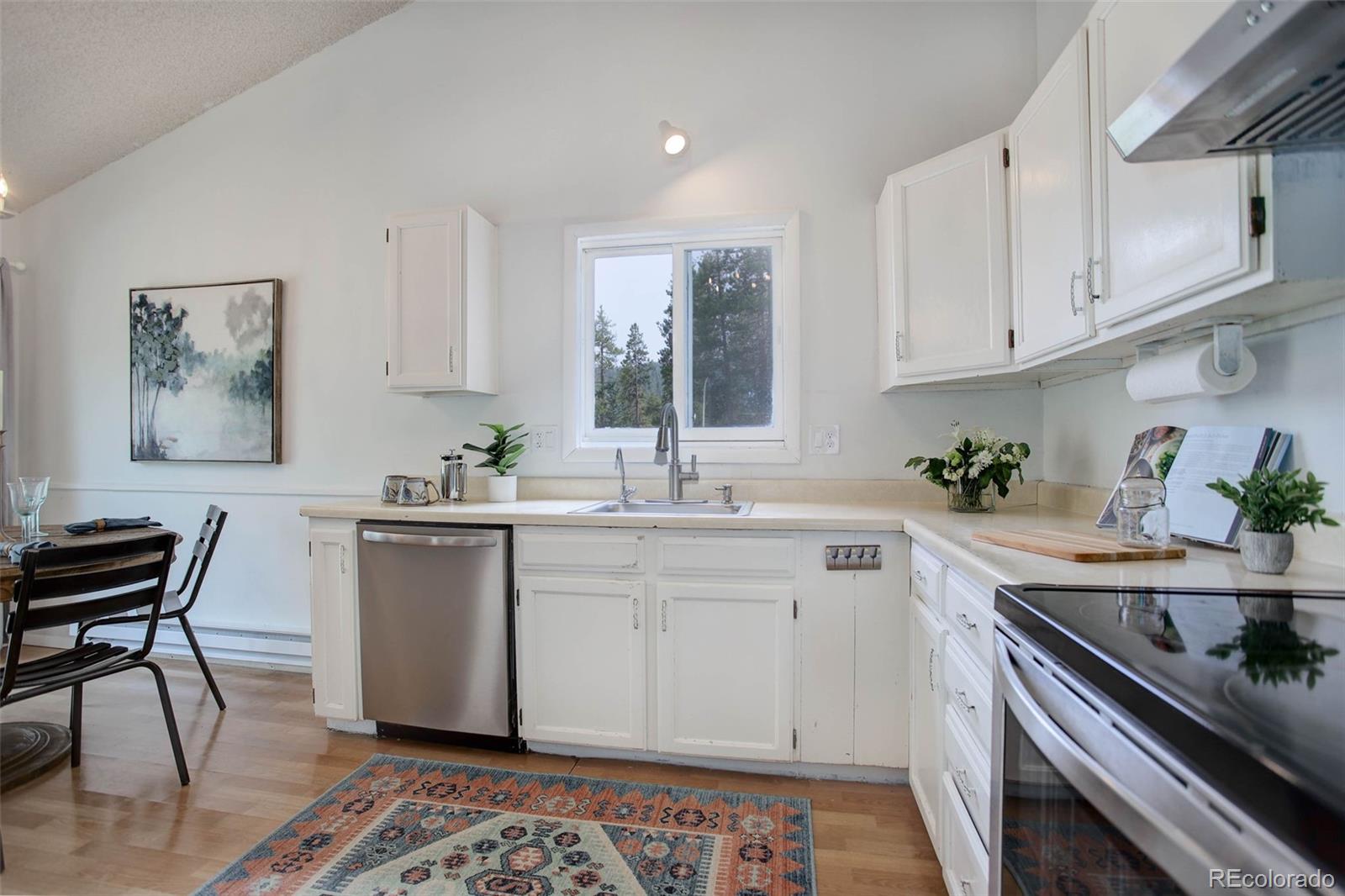 7359 Brook Forest Way Evergreen, CO 80439 - Photo 11 of 40 a kitchen with a sink and cabinets
